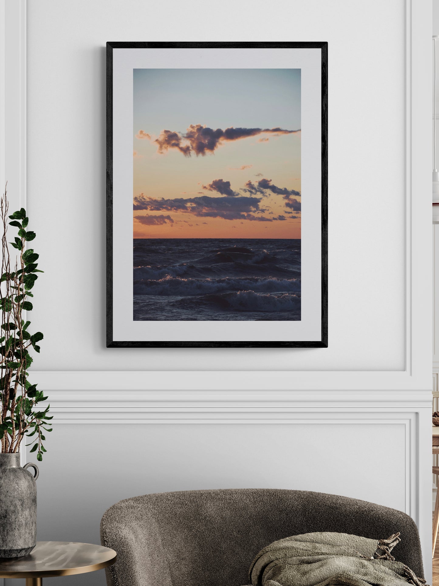 Fine art photography print of a sunset over Lake Michigan, framed and displayed in a stylish interior setting.