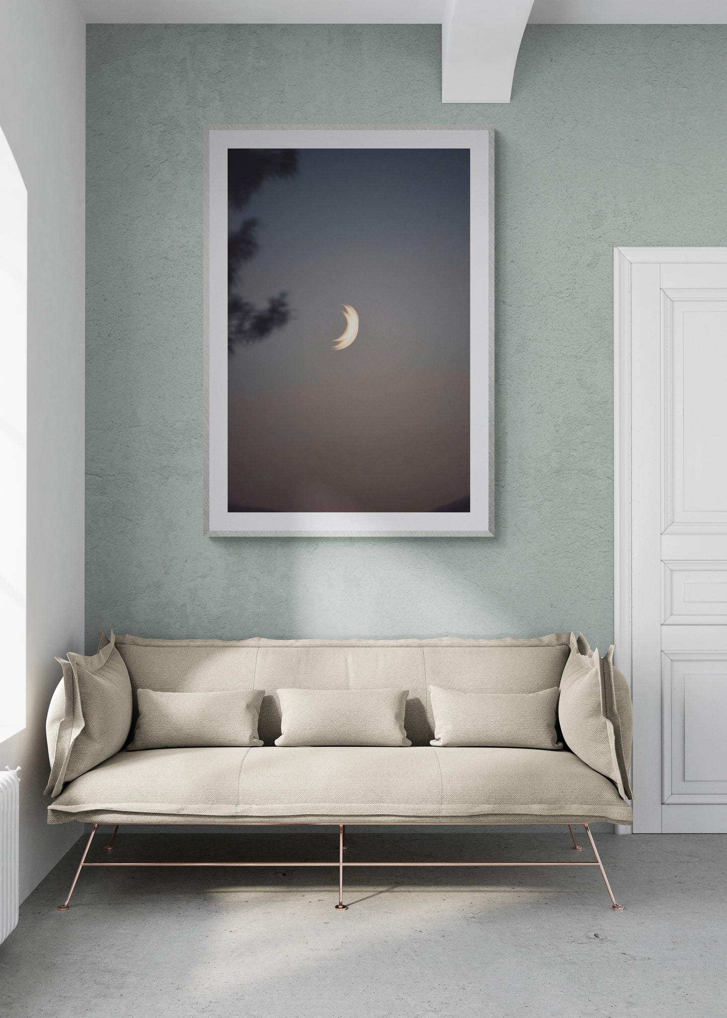 Fine art photography print "Two Moons" displayed in modern living room with minimalist decor.