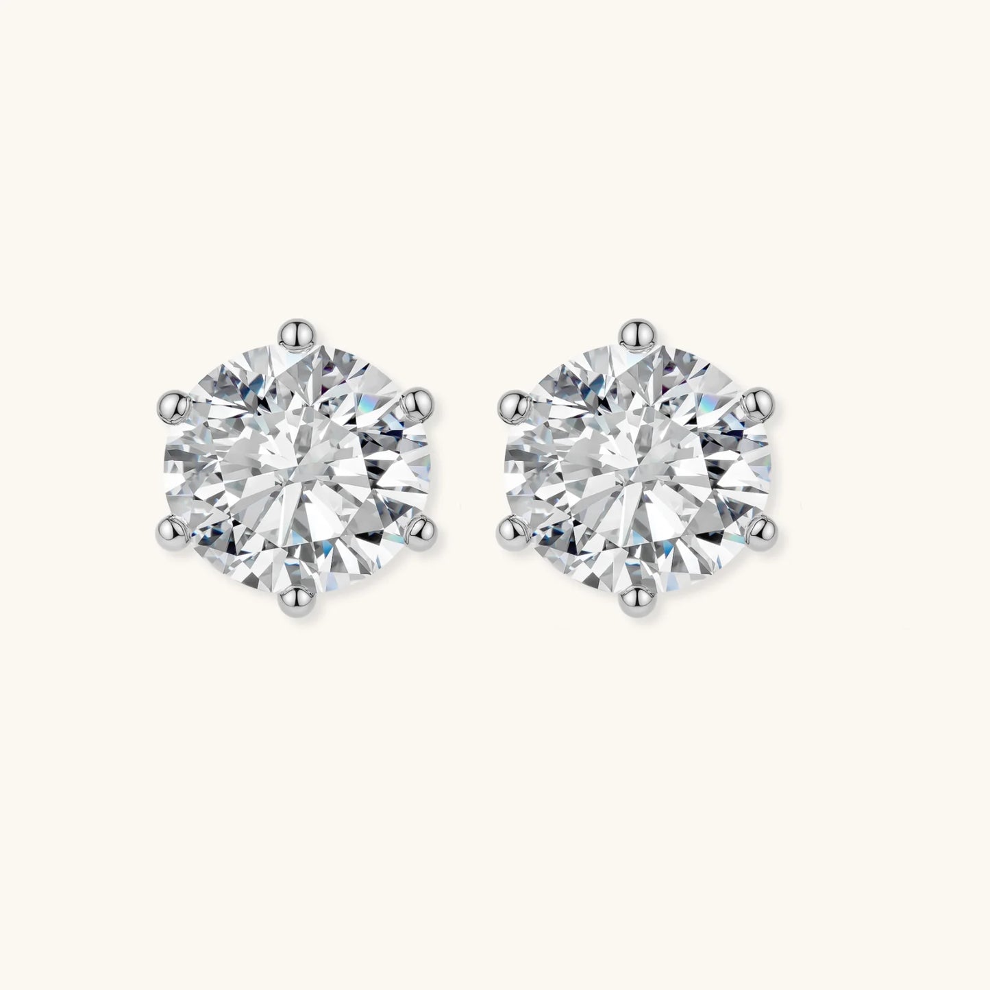 Close-up of round brilliant-cut moissanite stud earrings in 6-prong sterling silver settings showing exceptional sparkle