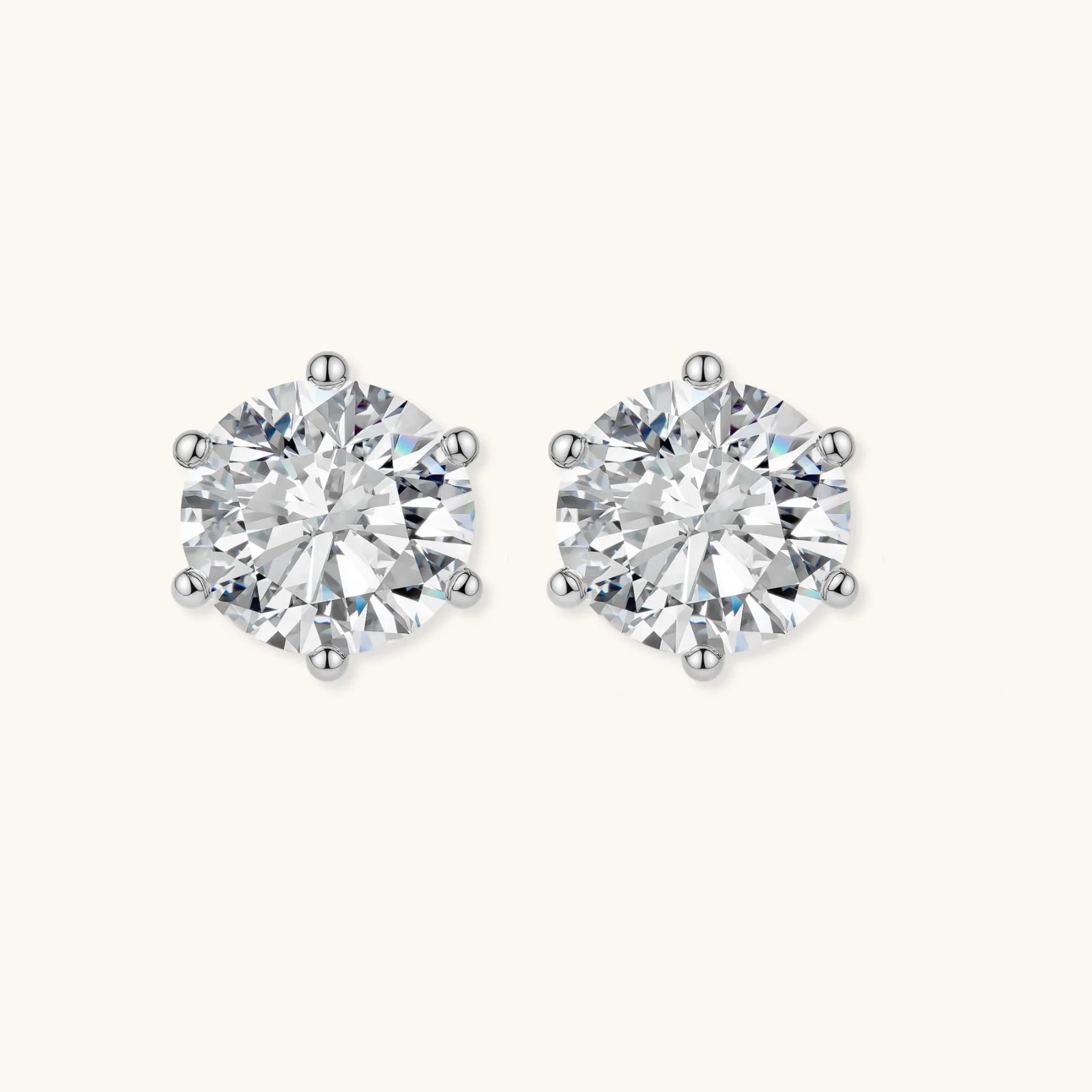 Close-up of round brilliant-cut moissanite stud earrings in 6-prong sterling silver settings showing exceptional sparkle